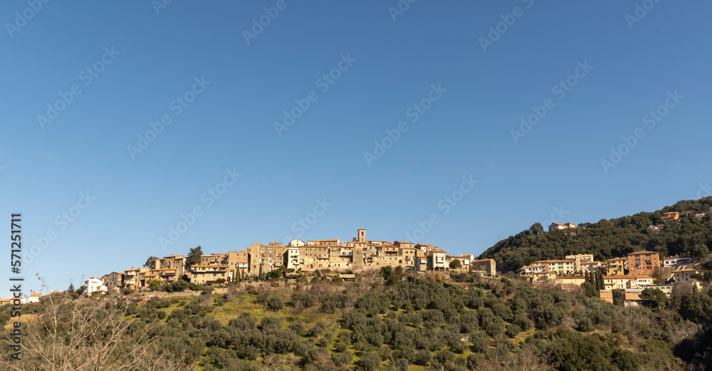 Italy Grosseto Maremma, route in MTB and EMTB in the woods of Gavorrano up to Mount Calvo, panoramic view of the village and the valley to the sea, Elba Island in the background