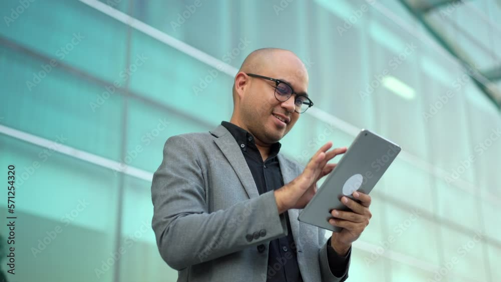 Confident smartly businessman manager smiling and using tablet in a modern office. CEO, business owner check balance from tablet proud of his success goals. Portrait Middle eastern trader. Confident smartly businessman manager smiling and using tablet in a modern office. CEO, business owner check balance from tablet proud of his success goals. Portrait Middle eastern trader.
