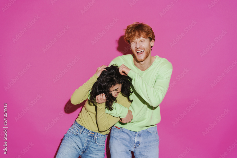 Obraz premium White young man and woman hugging and laughing at camera