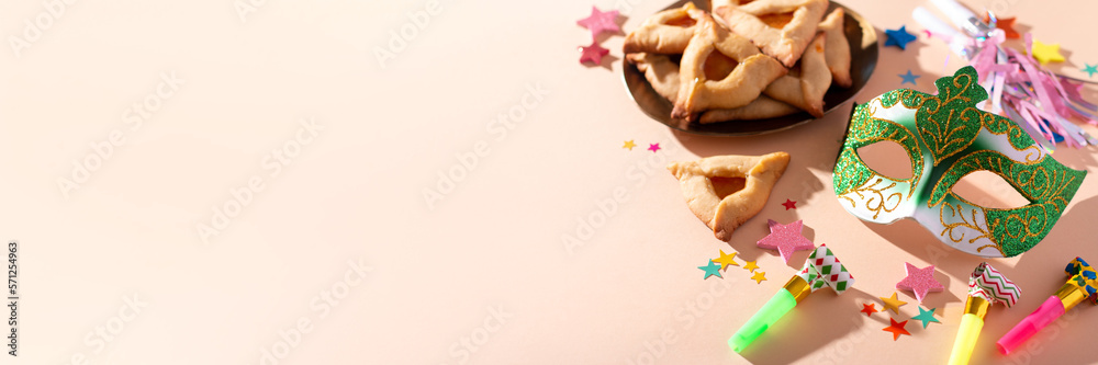 Purim web banner with hamantaschen cookies, carnival mask, holiday decor in hard light