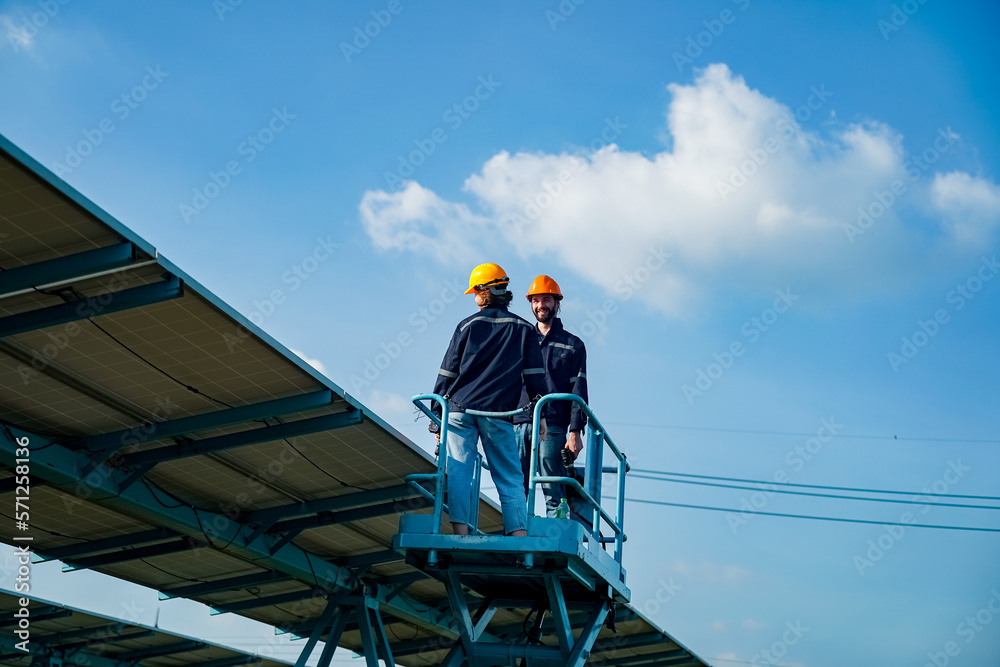 Maintenance engineer, Solar energy systems engineer perform analysis solar panels, Engineer service check installation solar cell on the roof of factory. Maintenance engineer, Solar energy systems engineer perform analysis solar panels, Engineer service check installation solar cell on the roof of factory.