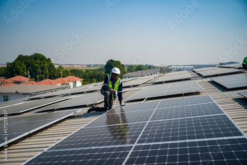 Technology solar cell  Engineer service check installation solar cell on the roof of factory. technician checks the maintenance of the solar panels