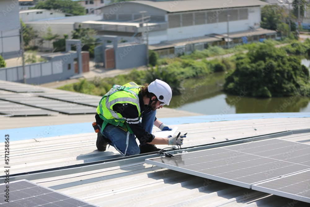 Technology solar cell, Engineer service check installation solar cell on the roof of factory. technician checks the maintenance of the solar panels Technology solar cell, Engineer service check installation solar cell on the roof of factory. technician checks the maintenance of the solar panels