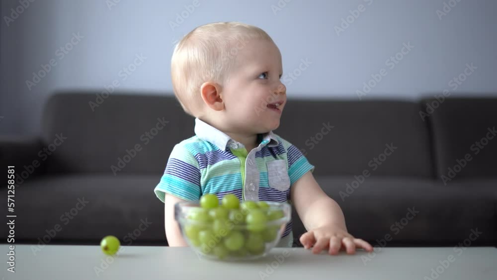 Little cute boy eats fresh grapes Little cute boy eats fresh grapes
