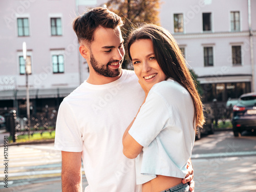 Smiling beautiful woman and her handsome boyfriend. Woman in casual summer jeans clothes. Happy cheerful family. Female having fun. Sexy couple posing in the street at sunny day © halayalex