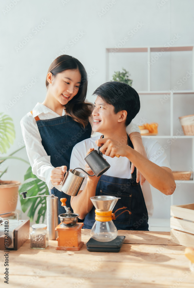 Young Asian couple doing holiday together in the kitchen happily wearing apron. love and valentine concept Young Asian couple doing holiday together in the kitchen happily wearing apron. love and valentine concept