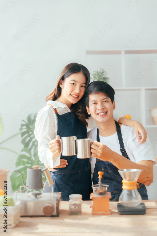 Young Asian couple doing holiday together in the kitchen happily wearing apron. love and valentine concept Young Asian couple doing holiday together in the kitchen happily wearing apron. love and valentine concept