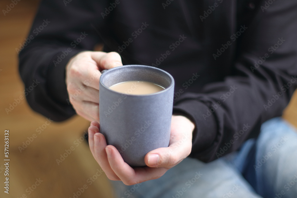 person holds a cup with coffee person holds a cup with coffee