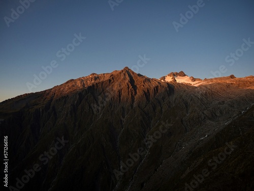 Alpine mountain sunset panorama of Mount Armstrong summit glacier seen from Brewster Hut track Southern Alps New Zealand