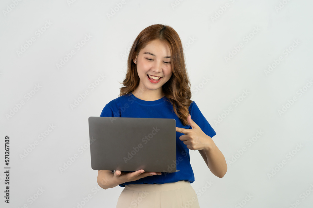 Cute Asian teenage woman smiling happily excited excitedly working with computer on white background Cute Asian teenage woman smiling happily excited excitedly working with computer on white background