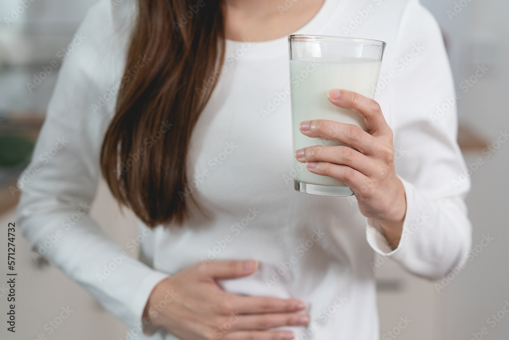 lactose intolerance concept. Woman having a stomach ache from lactose intolerance. lactose intolerance concept. Woman having a stomach ache from lactose intolerance.