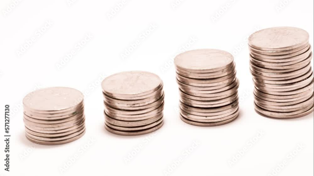 close up stop motion pile of silver coins on white background close up stop motion pile of silver coins on white background