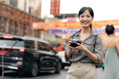 Young Asian woman backpack traveler enjoying China town street food market in Bangkok, Thailand. Traveler checking out side streets.