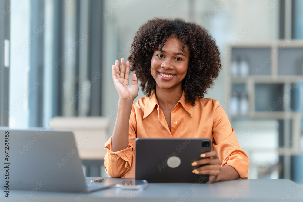 Using tablet pc, Young pretty african american business woman bookkeepers working with balance sheet yearly reports to calculate tax and online consult in modern office.