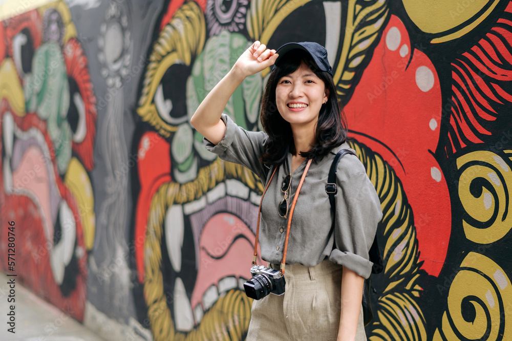 Young Asian woman backpack traveler enjoying street cultural local place and smile. Traveler checking out side streets. Journey trip lifestyle