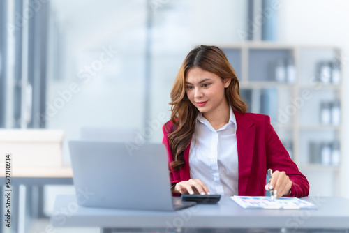 Young pretty business woman bookkeepers online consult on laptop with stock market earning and profit, tax, yearly planning, Powerful expert management complete bookkeeping service and solutions