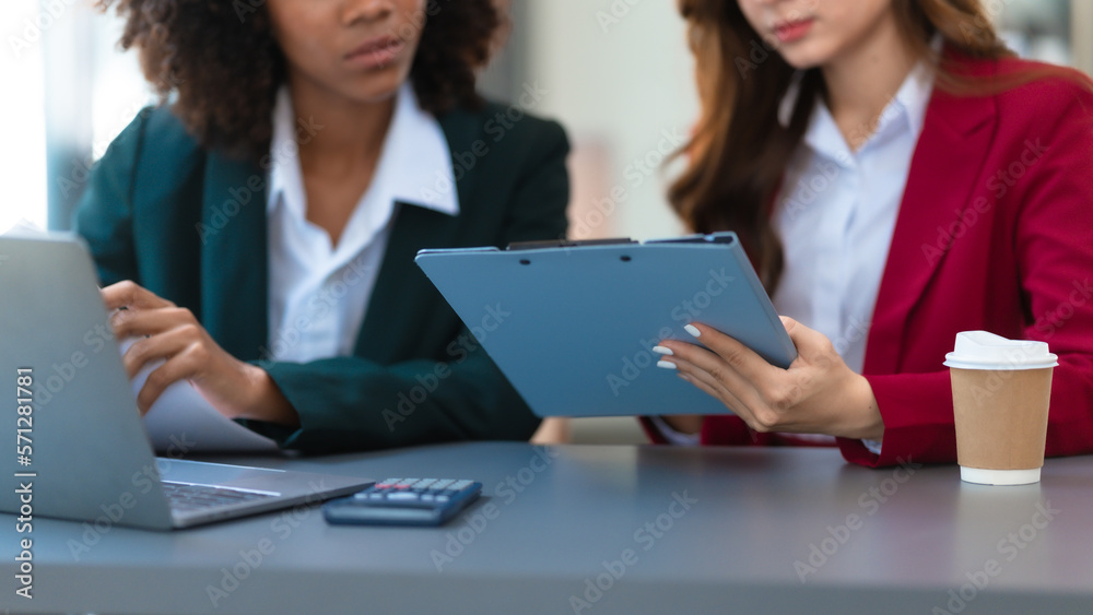 Young trader mixed race woman in formal suit friends consulting and discussing with stock market and cryptocurrency in online trading application. Young trader mixed race woman in formal suit friends consulting and discussing with stock market and cryptocurrency in online trading application.