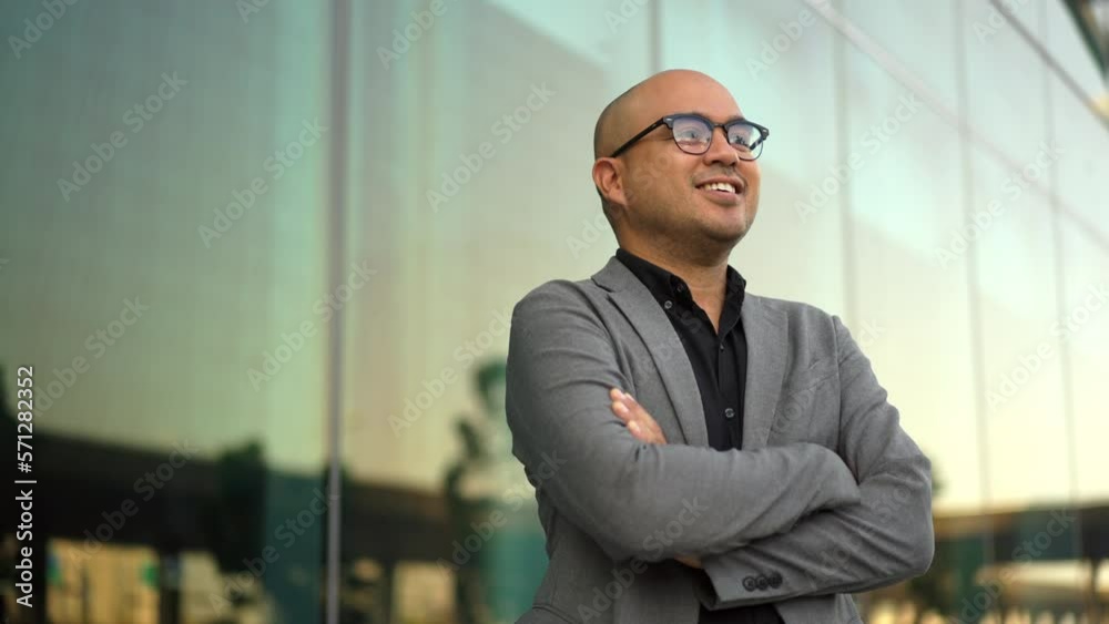 Confident smartly businessman manager smiling and arms crossed standing in a modern office. CEO, business owner proud of his success goals. Portrait Middle eastern businessman trader smiling. Confident smartly businessman manager smiling and arms crossed standing in a modern office. CEO, business owner proud of his success goals. Portrait Middle eastern businessman trader smiling.