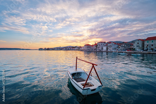 Fototapeta Naklejka Na Ścianę i Meble -  Beautiful sunset landscape. Fishing boat moored on Kastel coast in Dalmatia,Croatia.Old town near Adriatic sea.