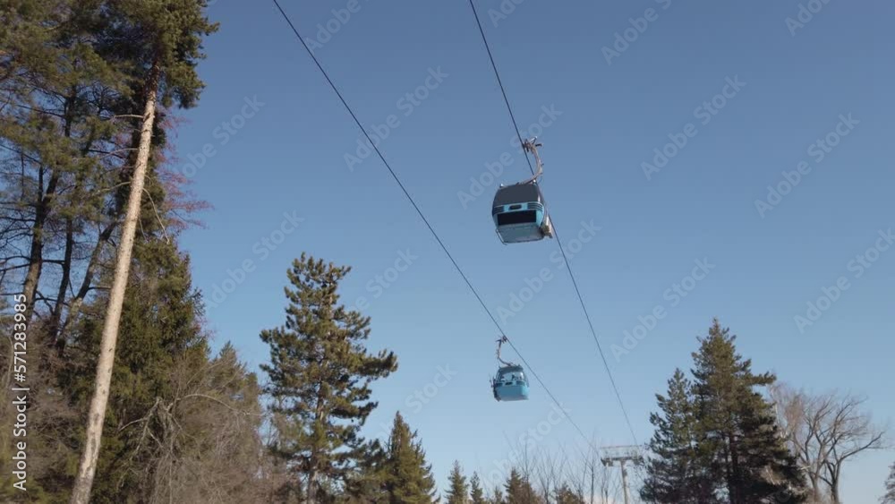 Ski lift cabin gondolas against over slope at ski resort, slow motion Ski lift cabin gondolas against over slope at ski resort, slow motion