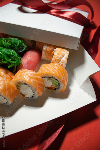 salmon tuna chuka shrimp eel sushi rolls set with red ribbon