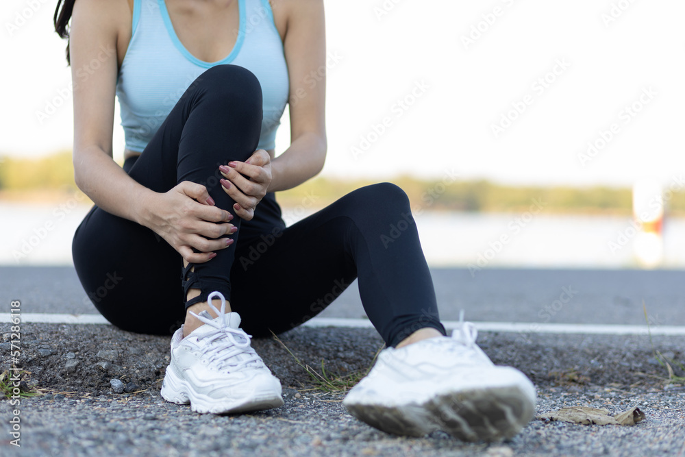 The female athlete suffered an ankle injury. A female runner has pain