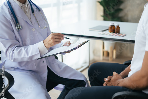 Doctor and patient are discussing consultation about symptom problem diagnosis of disease talk to the patient about medication and treatment method.