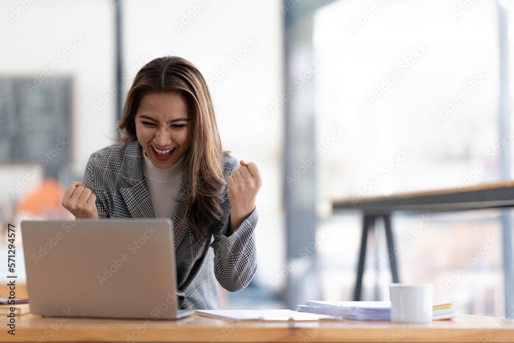 Young happy Asian businesswoman working and use laptop and thinking idea for her business Young happy Asian businesswoman working and use laptop and thinking idea for her business