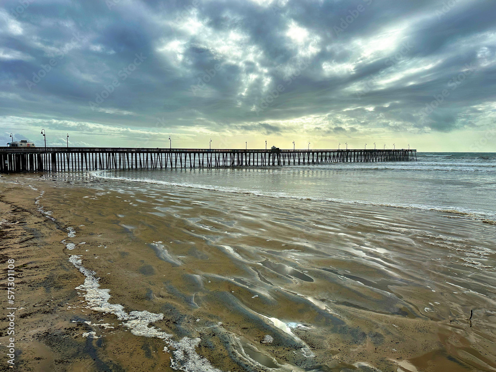 Pismo Pier with stormy skies at sunset
