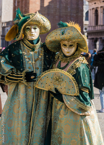 People wearing elaborate and colorful costumes and masks during the Venice 2023 carnival in Venice, Italy