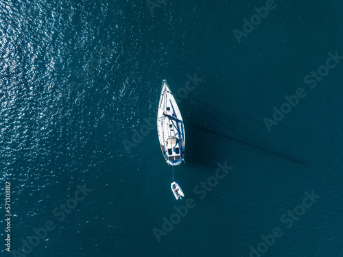Aerial view of yacht in deep blue sea by the Gran Canaria coastline. Amazing view of luxury yachts sailing in open sea on a calm day.