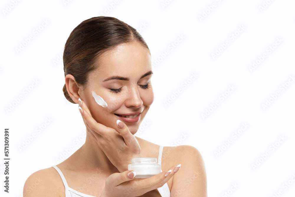 Beauty skin woman natural makeup face cosmetic concept.Beautiful portrait of female face holding and applying cosmetic cream. Skin care.