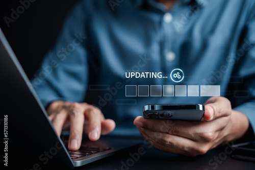 Fototapeta Naklejka Na Ścianę i Meble -  Update software system in computer. Man using smartphone upgrade program, Business technology internet loading virtual bar with installing the update for the quality better...
