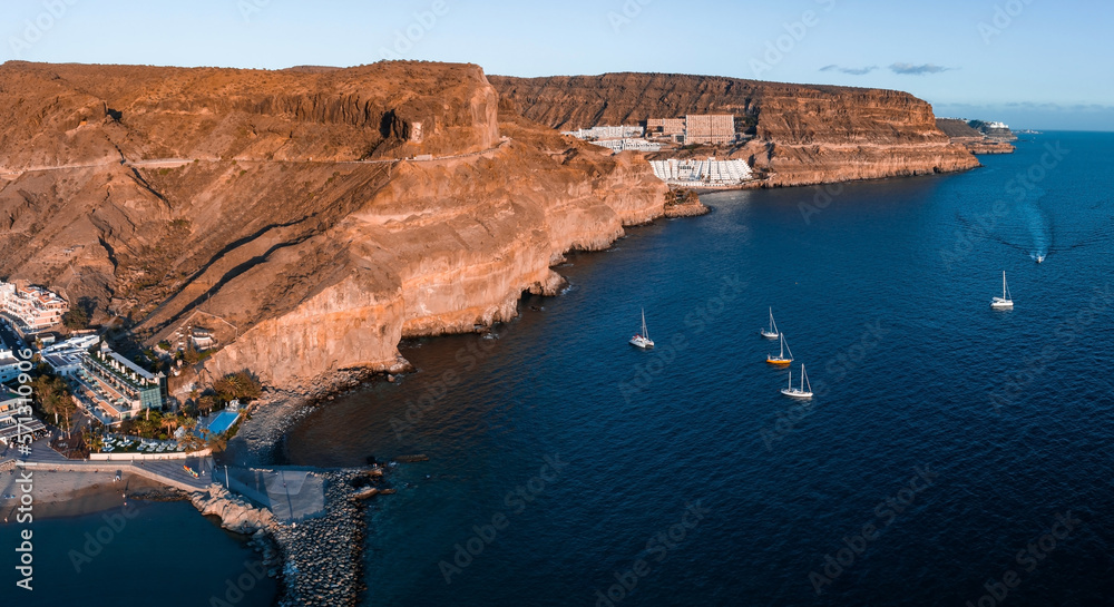 Puerto de Mogan fishing town aerial view at sunset. Traditional colorful buildings with many fishing boats at Gran Canaria, Canary Islands, Spain
