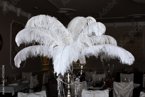 White ostrich feather in vase on a banquet table. photo