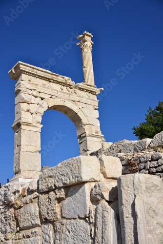 ancient arch with column of Sagalassos isolated on blue sky, close-up
