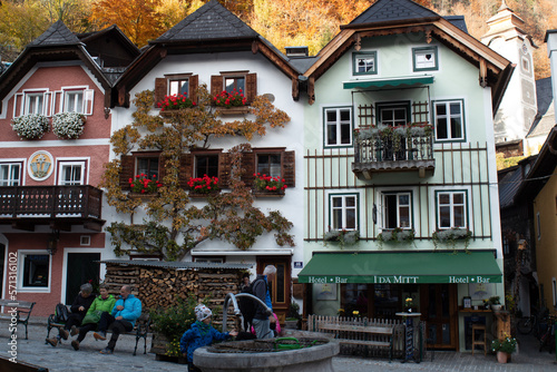 hallsttat mountain village surrounded by lakes and trees in autumn