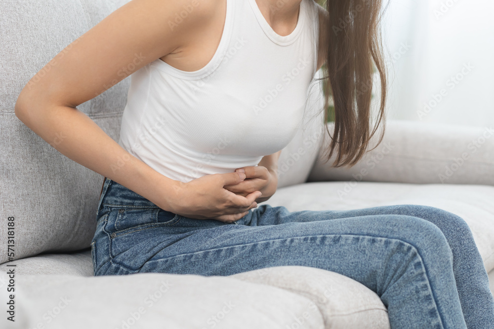 Flatulence asian young woman, girl hand in stomach ache, suffer from food poisoning, abdominal pain and colon problem, gastritis or diarrhoea. Patient belly, abdomen or inflammation, concept. Flatulence asian young woman, girl hand in stomach ache, suffer from food poisoning, abdominal pain and colon problem, gastritis or diarrhoea. Patient belly, abdomen or inflammation, concept.