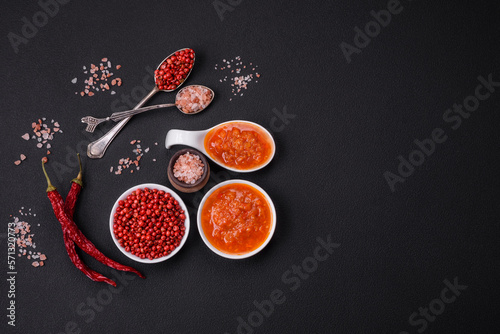 Red adjika sauce or ketchup with spices and herbs