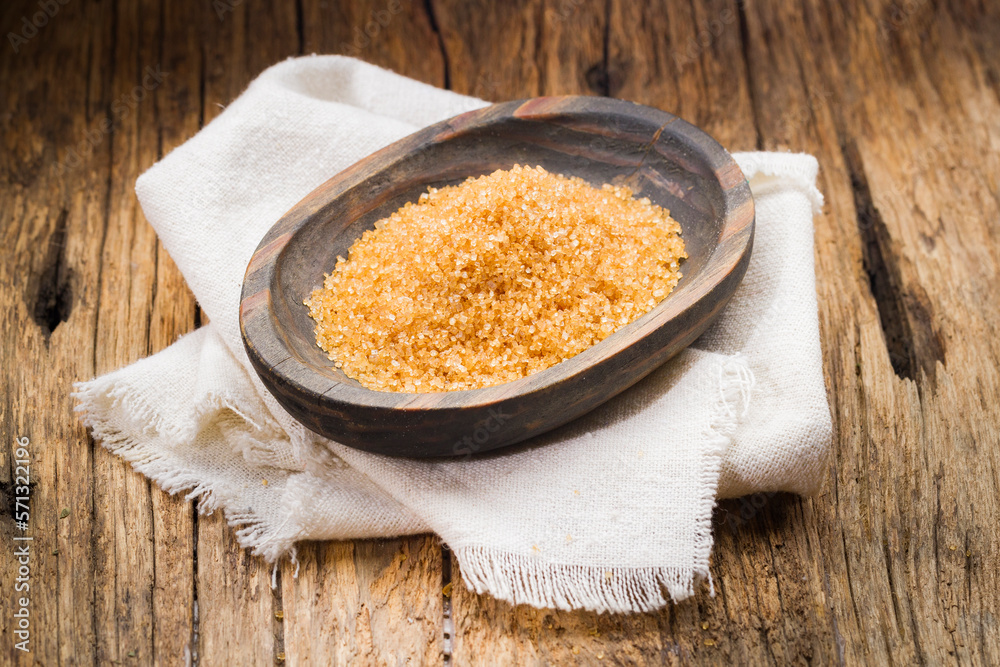 brown sugar in wooden container, food derived from sugar cane brown sugar in wooden container, food derived from sugar cane