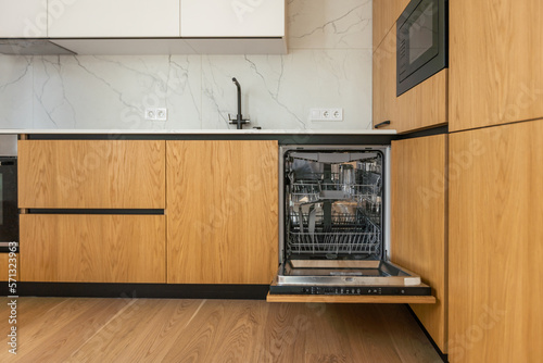 Obraz na plátně Modern kitchen with empty Built-in dishwasher with opened door, Stainless steel