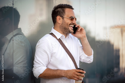 Handsome businessman using smart phone at the city