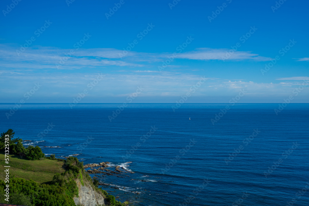 Landscape overlooking green hill and the Atlantic Ocean. Coast of Basque Country, Spain