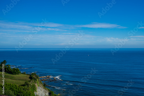 Landscape overlooking green hill and the Atlantic Ocean. Coast of Basque Country, Spain