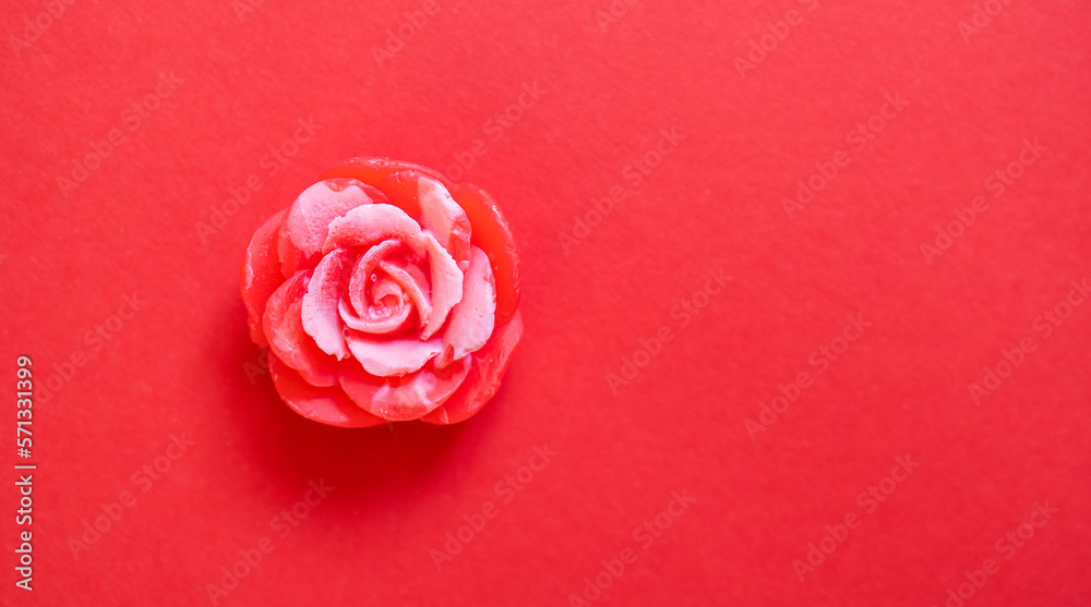 Handmade soap. Solid soap in the shape of a red rose flower. Red background. Handmade soap. Solid soap in the shape of a red rose flower. Red background.
