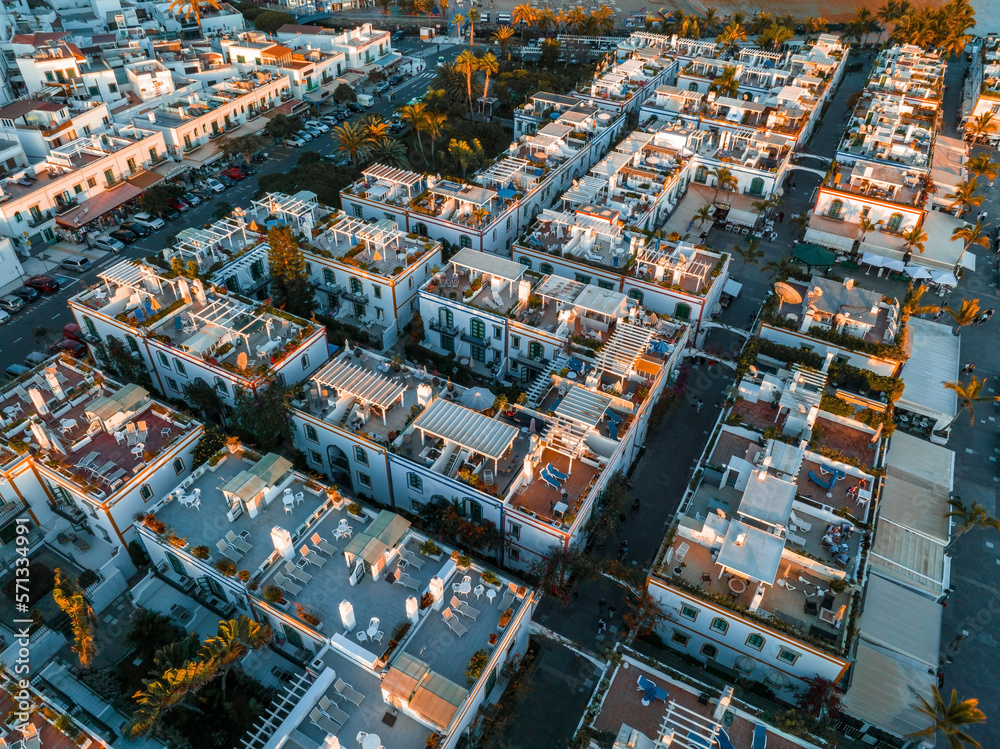 Obraz premium Puerto de Mogan fishing town aerial view at sunset. Traditional colorful buildings with many fishing boats at Gran Canaria, Canary Islands, Spain