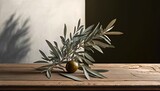  an olive tree branch on a wooden table with a shadow of a tree behind it on a black wall in a room with white walls.  generative ai