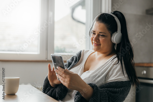 A woman is listening to music at home