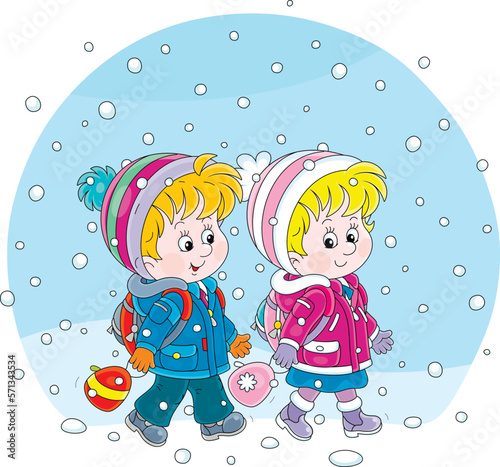 Happy little schoolboy and schoolgirl with their backpacks cheerfully chatting and going to school through snowfall on a cold winter morning, vector cartoon illustration