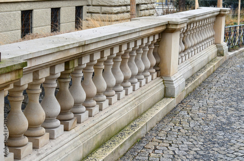 beige stone railing of a historic building balustrade reminiscent of a skittles Fototapet